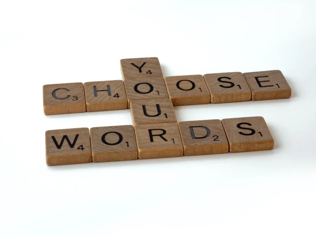 Wooden scrabble letters spell out "choose your words wisely" - this is important advice for media interviews